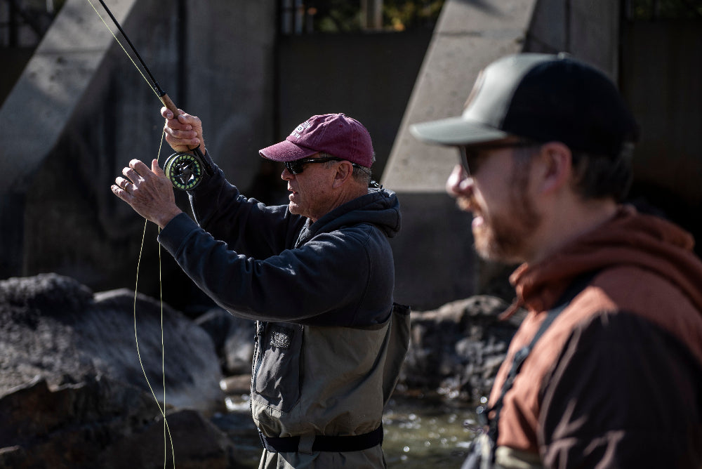 An angler reels in a 14 inch Maine brook trout on a guided fly fishing trip with New England Fly Company.